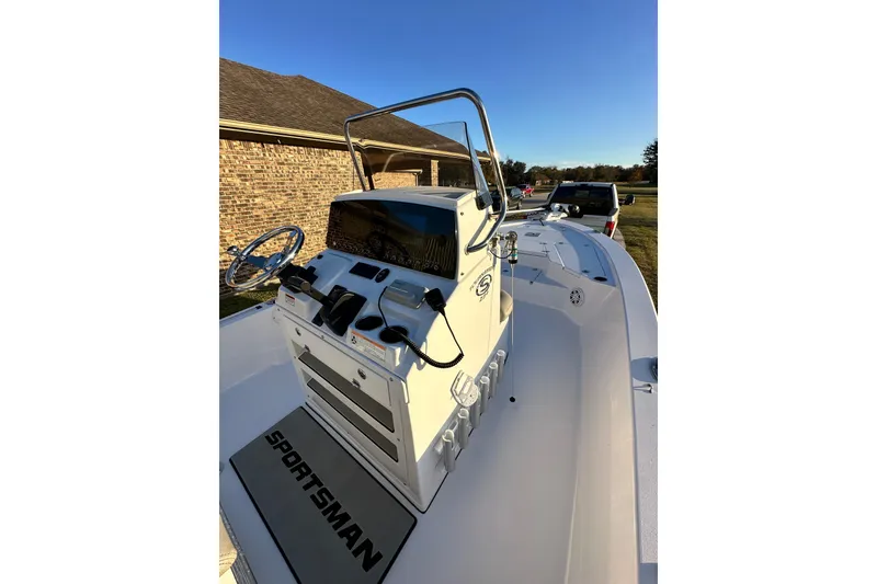 Slide: The Image of 2023 Sportsman Tournament 234 Bay Boat with console and steering wheel, parked outdoors. - 40