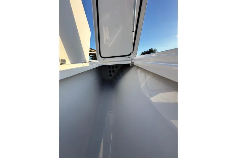 Slide: The Image of 2023 Sportsman Tournament 234 Bay Boat storage compartment with open hatch, showcasing sleek design. - 44
