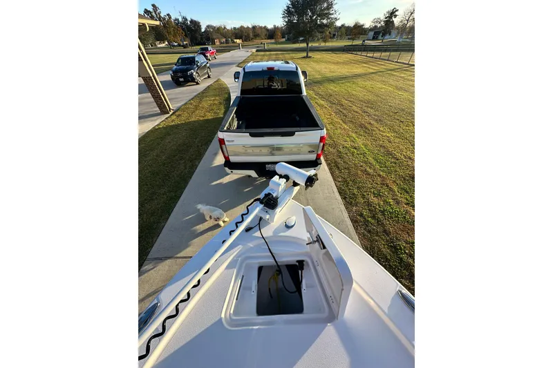 Slide: The Image of 2023 Sportsman Tournament 234 Bay Boat on driveway, parked behind a white pickup truck. - 48