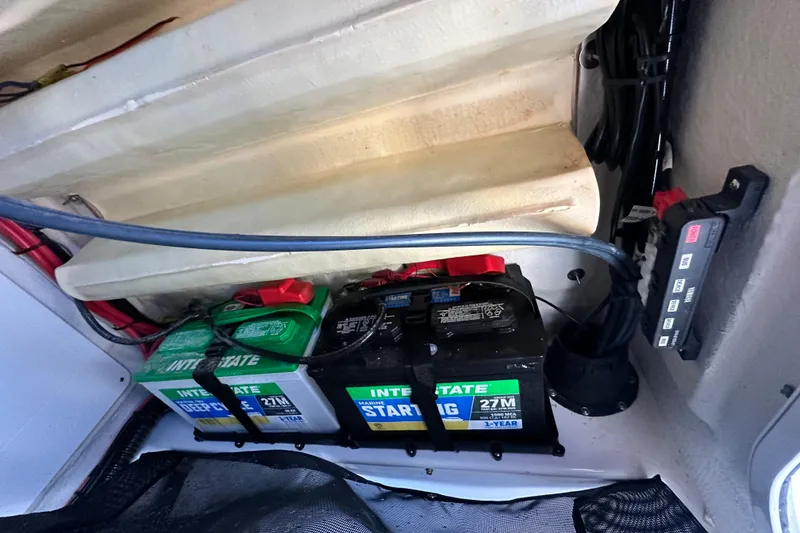 Slide: The Image of 2023 Sportsman Tournament 234 Bay Boat battery compartment with Interstate batteries and wiring. - 58