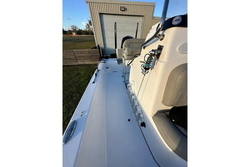 Slide: The Image of 2023 Sportsman Tournament 234 Bay Boat, side view, parked near a building. - 60