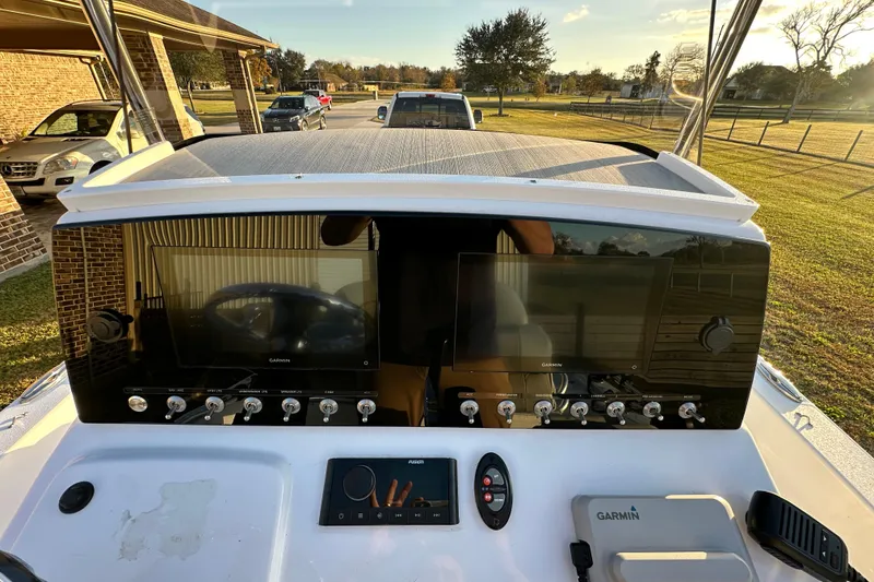 Slide: The Image of 2023 Sportsman Tournament 234 Bay Boat dashboard with dual Garmin displays and control panel. - 61