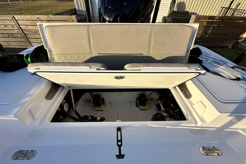 Slide: The Image of 2023 Sportsman Tournament 234 Bay Boat with open storage compartment and cushioned seating. - 64