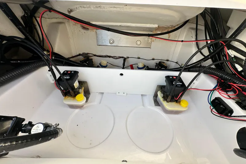 Slide: The Image of 2023 Sportsman Tournament 234 Bay Boat wiring and battery compartment. - 65