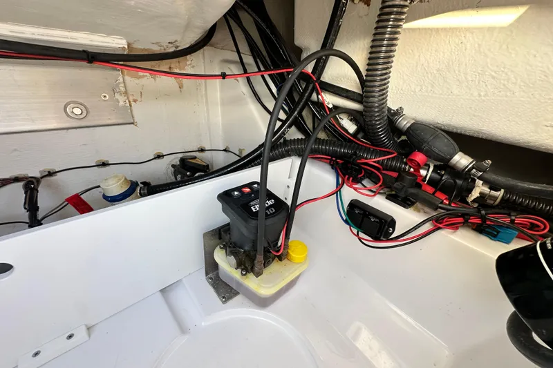 Slide: The Image of 2023 Sportsman Tournament 234 Bay Boat wiring and components in the engine compartment. - 66