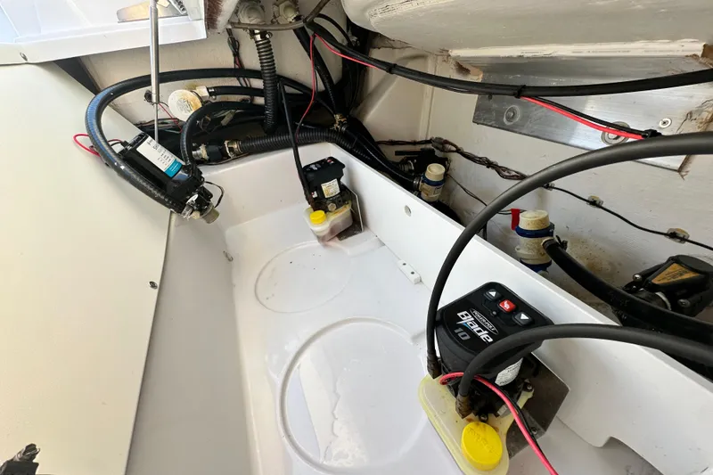 Slide: The Image of 2023 Sportsman Tournament 234 Bay Boat wiring and components in the engine compartment. - 67