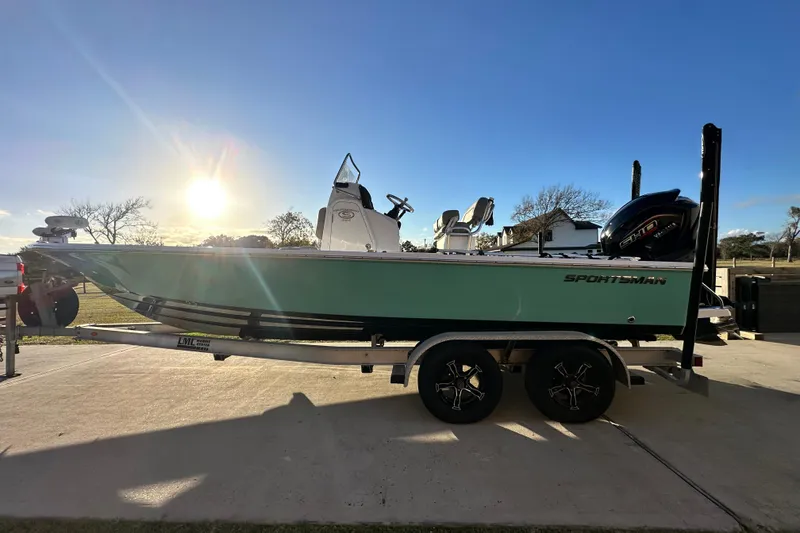 Slide: The Image of 2023 Sportsman Tournament 234 Bay Boat on trailer, sunlit background. - 7