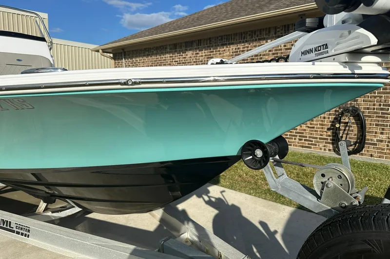 Slide: The Image of 2023 Sportsman Tournament 234 Bay Boat on trailer, featuring Minn Kota Terrova motor. - 8