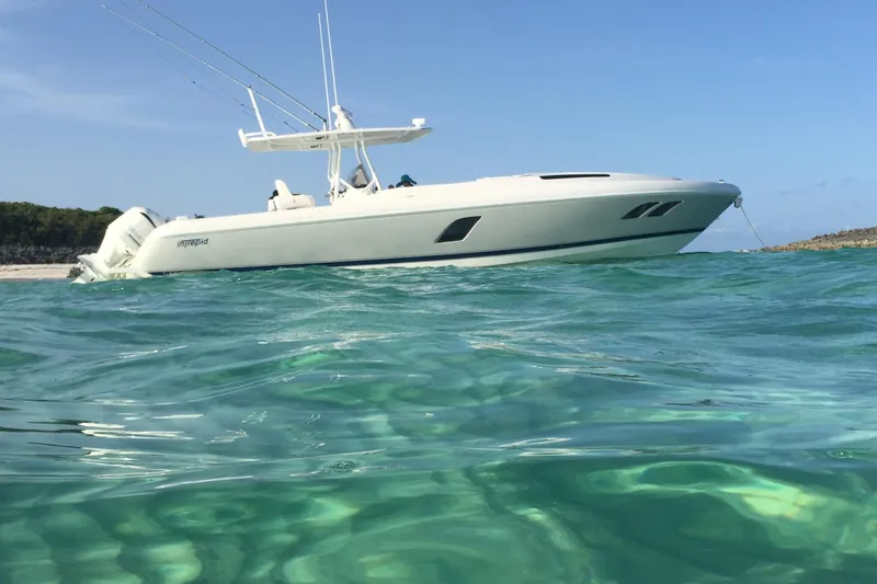 Slide: The Image of 2015 Intrepid 400 Cuddy boat anchored in clear turquoise water. - 1
