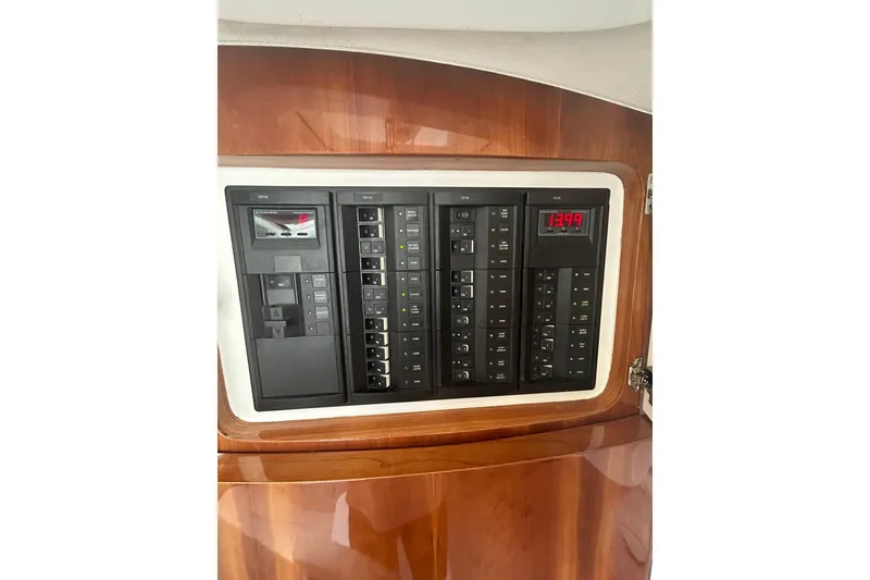 Slide: The Image of Control panel of a 2015 Intrepid 400 Cuddy boat, featuring switches and digital display. - 10