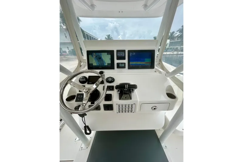 Slide: The Image of Control panel of a 2015 Intrepid 400 Cuddy boat with navigation screens and steering wheel. - 5