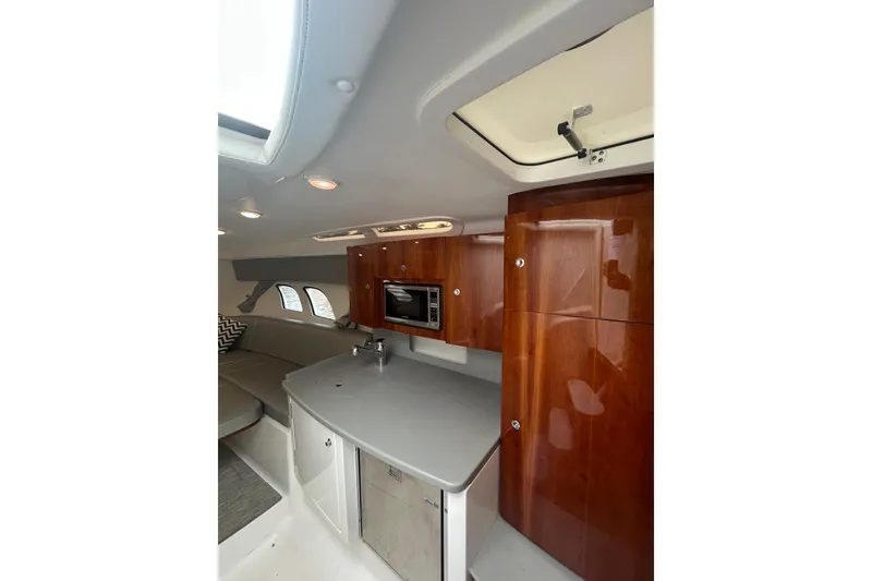 Slide: The Image of Interior of 2015 Intrepid 400 Cuddy featuring sleek cabinetry and modern amenities. - 7