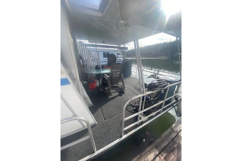 Slide: The Image of 1981 Sumerset houseboat deck with chairs and railing on a sunny day. - 11