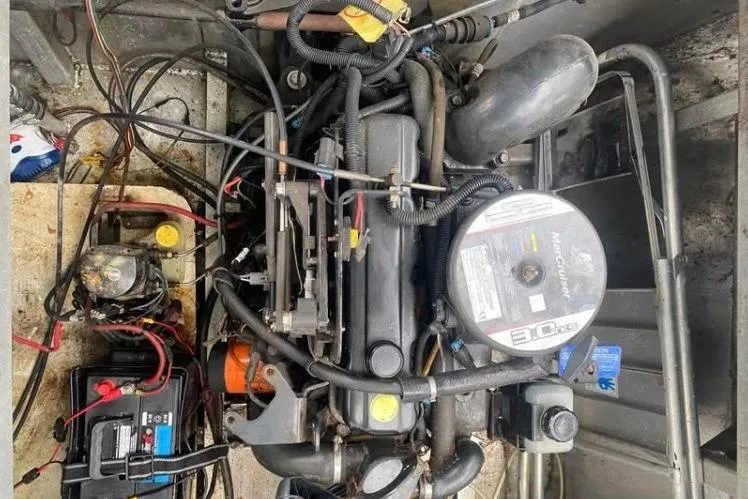 Slide: The Image of Engine compartment of a 1981 Sumerset houseboat, featuring wiring and mechanical components. - 12