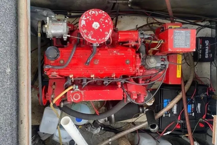 Slide: The Image of Red engine of a 1981 Sumerset houseboat, surrounded by wiring and components. - 14