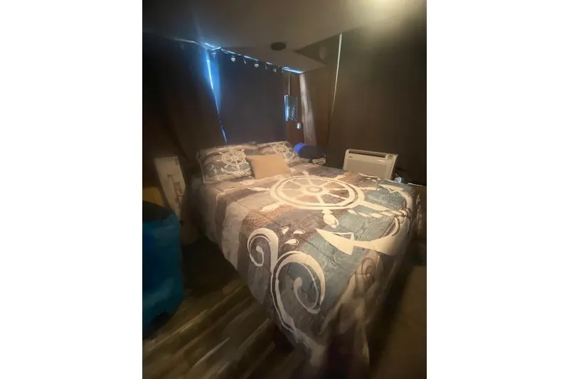 Slide: The Image of Cozy bedroom in 1981 Sumerset houseboat with nautical-themed bedding. - 7