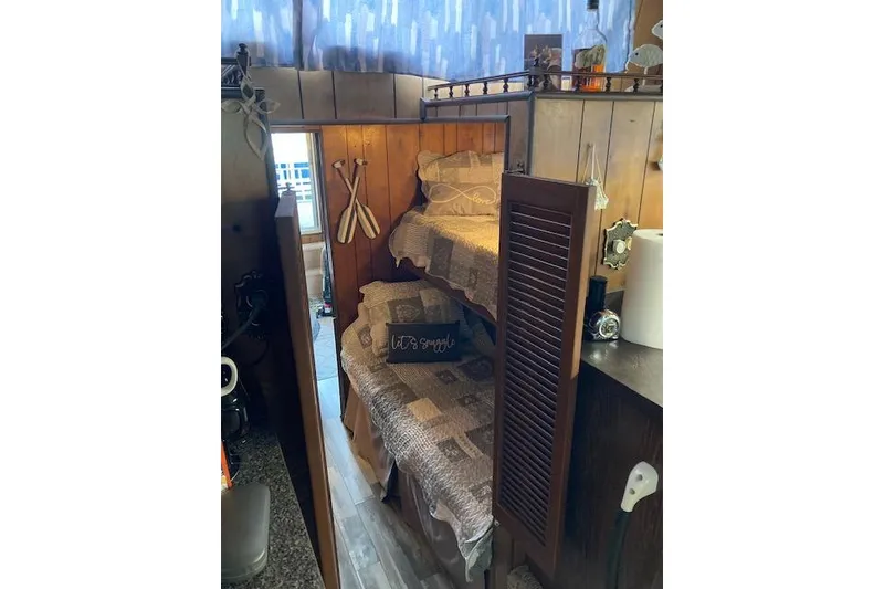 Slide: The Image of 1981 Sumerset houseboat interior with cozy bunk beds and nautical decor. - 8