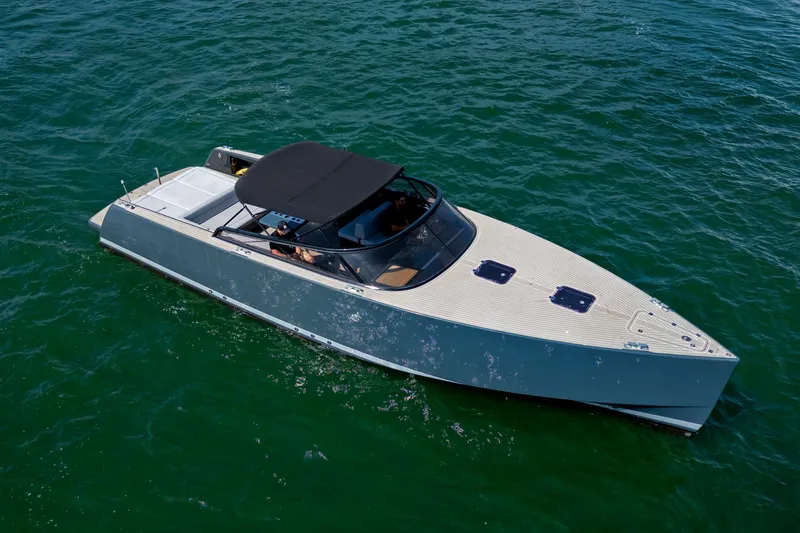 Slide: The Image of 2014 VanDutch 40 yacht cruising on open water, sleek design, black canopy. - 4