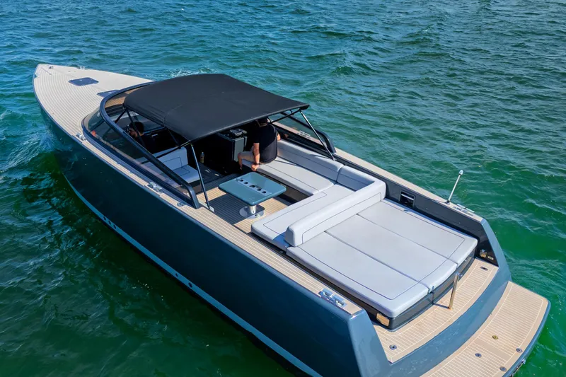 Slide: The Image of 2014 VanDutch 40 yacht cruising on clear blue water, featuring sleek design and spacious deck. - 8