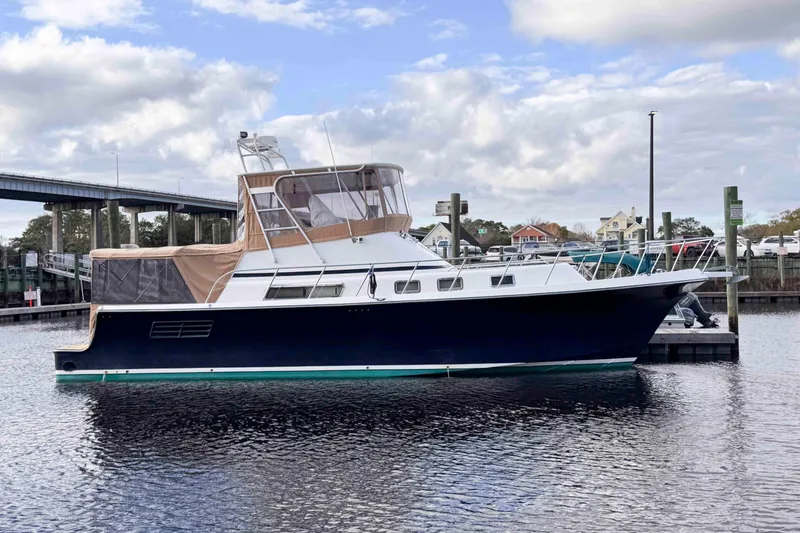 The Image of 2007 Albin 45 Command Bridge yacht docked at marina under cloudy sky. - 0