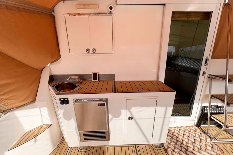 Slide: The Image of 2007 Albin 45 Command Bridge interior with kitchenette and sliding door. - 15