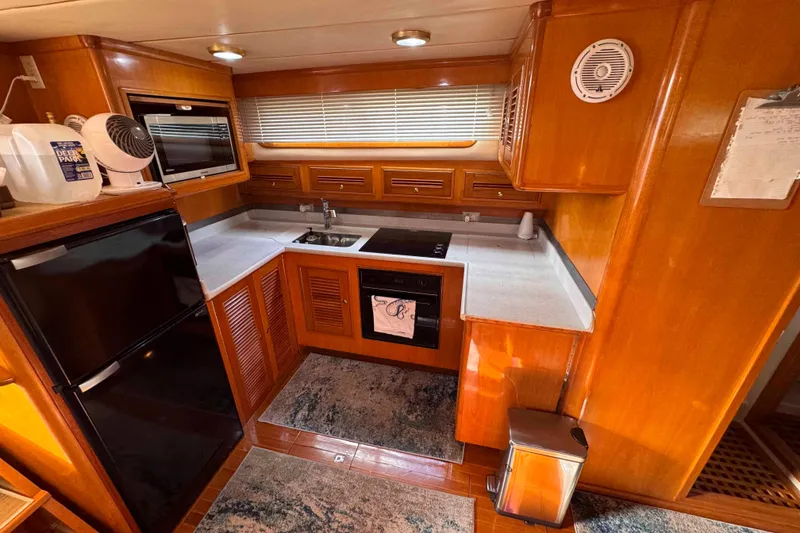 Slide: The Image of Luxurious 2007 Albin 45 Command Bridge kitchen with modern appliances and wood cabinetry. - 20