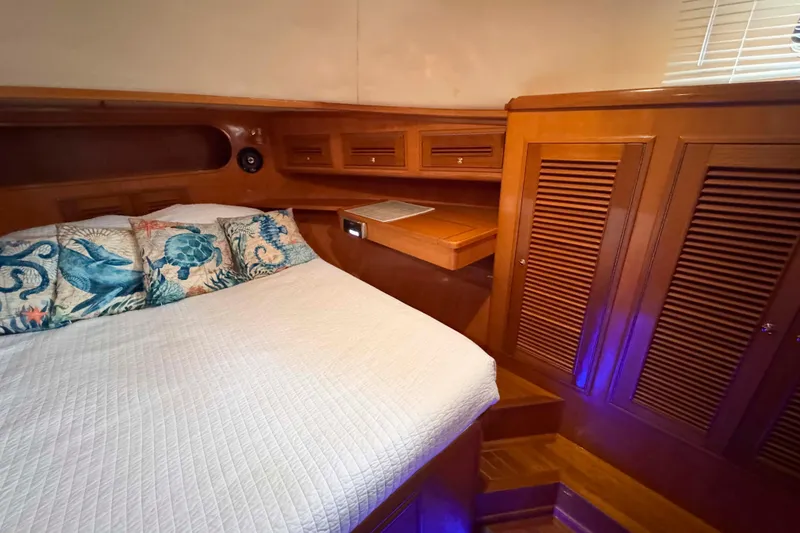 Slide: The Image of Luxurious 2007 Albin 45 Command Bridge cabin with nautical-themed pillows and wooden cabinetry. - 26