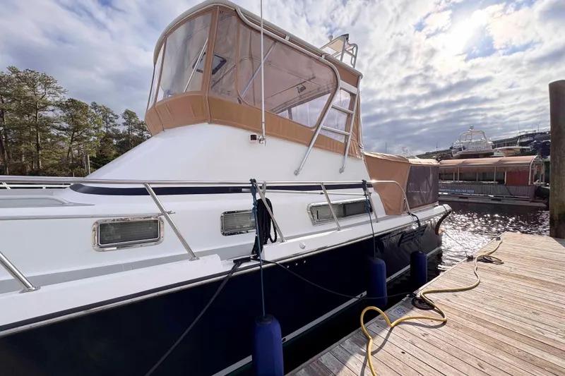 Slide: The Image of 2007 Albin 45 Command Bridge yacht docked at marina under cloudy sky. - 3