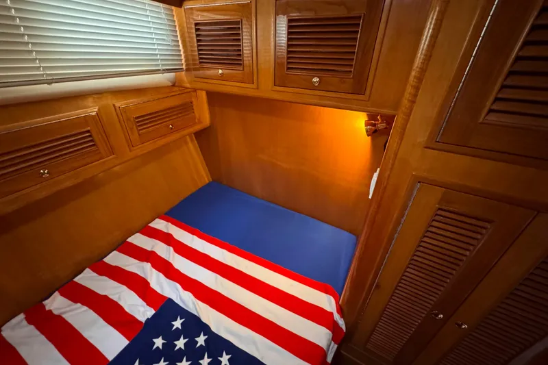 Slide: The Image of Cozy cabin interior of 2007 Albin 45 Command Bridge with American flag bedding. - 30