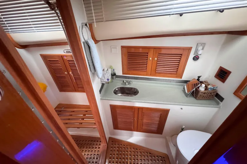 Slide: The Image of 2007 Albin 45 Command Bridge bathroom with wooden cabinets and modern fixtures. - 32