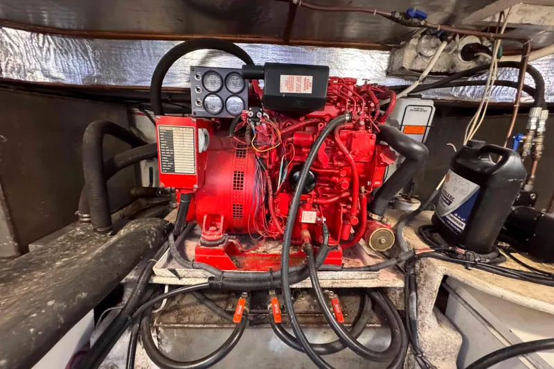 Slide: The Image of Engine room of a 2007 Albin 45 Command Bridge with a red marine engine. - 37