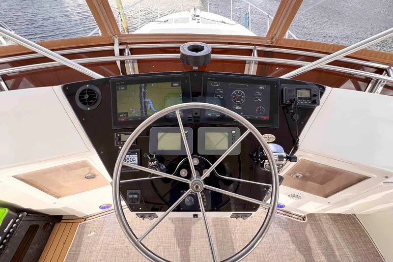 Slide: The Image of 2007 Albin 45 Command Bridge helm with navigation screens and steering wheel. - 7