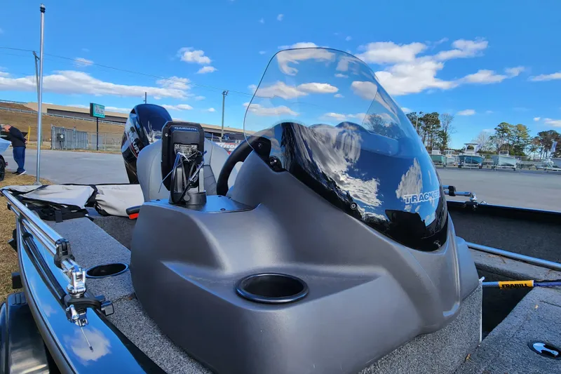 Slide: The Image of 2025 Tracker Pro Guide V-16 SC boat with windshield and Garmin device, under blue sky. - 11