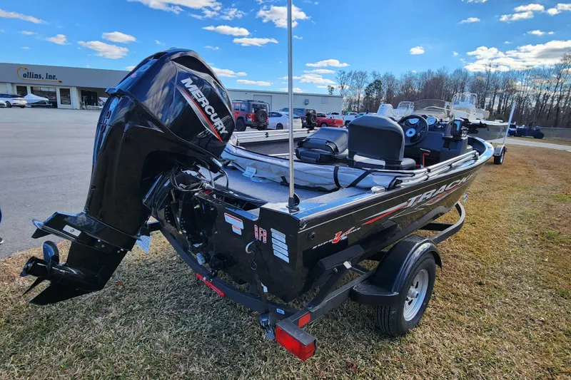 Slide: The Image of 2025 Tracker Pro Guide V-16 SC boat with Mercury engine, parked outdoors. - 4