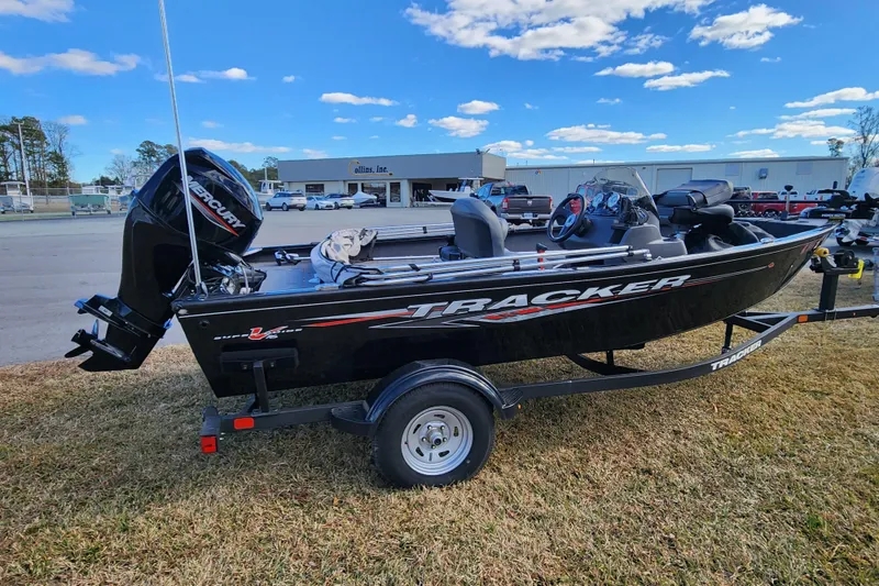 Slide: The Image of 2025 Tracker Pro Guide V-16 SC boat on trailer, parked outdoors under blue sky. - 5