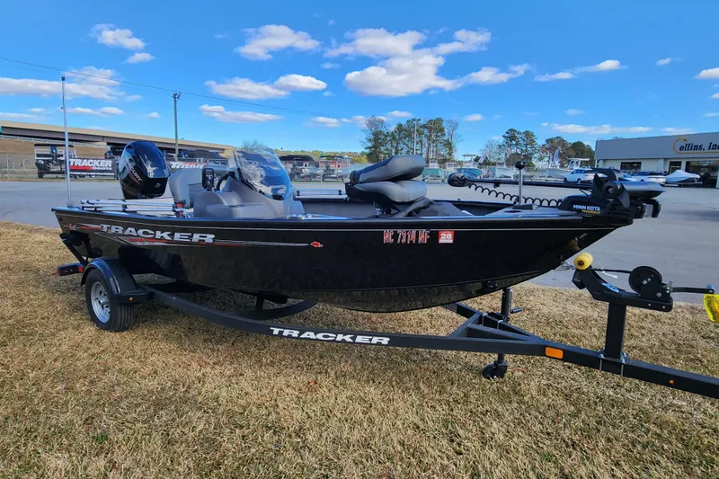 Slide: The Image of 2025 Tracker Pro Guide V-16 SC boat on trailer, parked outdoors under blue sky. - 6
