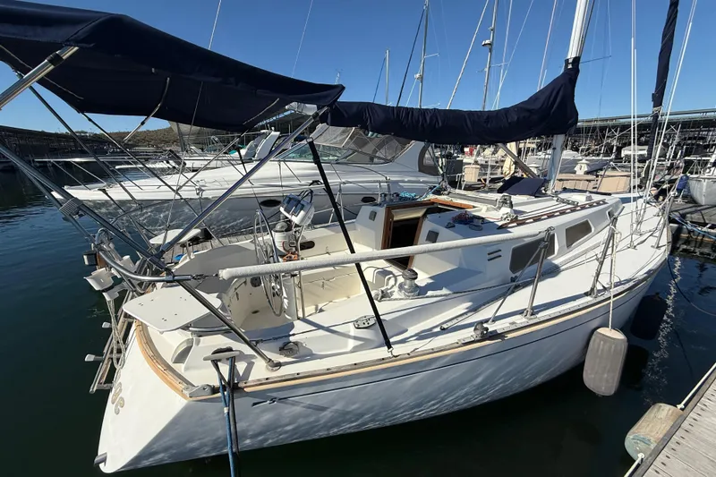 The Image of 1986 Sabre 30 MKIII sailboat docked in marina, featuring spacious cockpit and sleek design. - 1