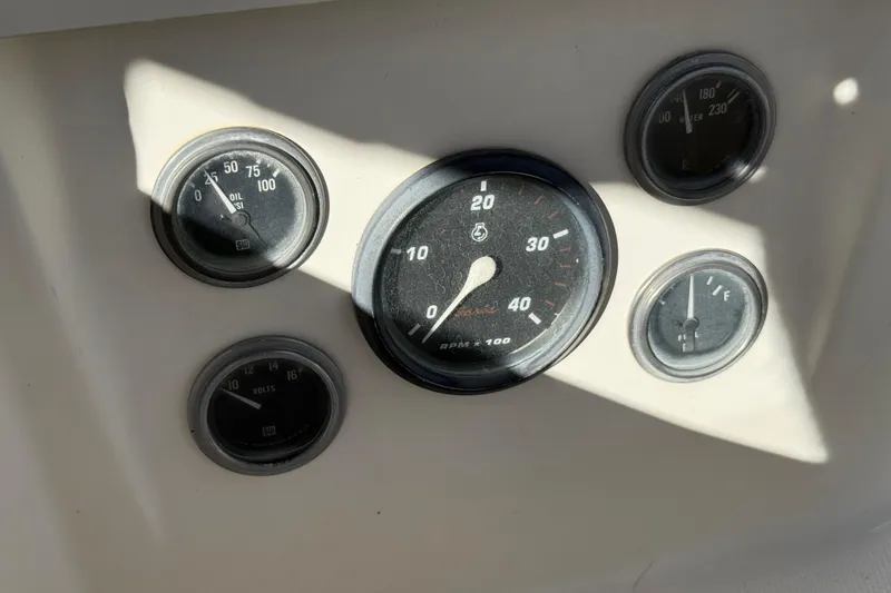 Slide: The Image of Dashboard gauges of a 1986 Sabre 30 MKIII sailboat, showing RPM, oil, and fuel levels. - 16