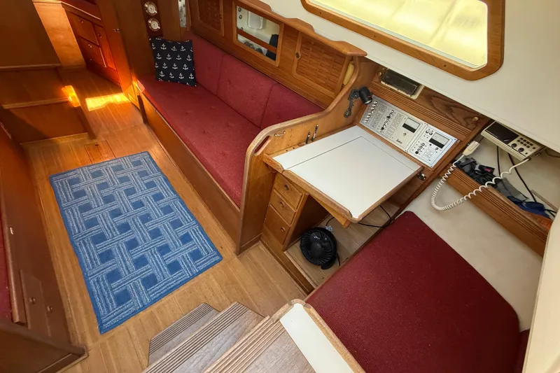 Slide: The Image of Interior of 1986 Sabre 30 MKIII sailboat with red seating and navigation station. - 30