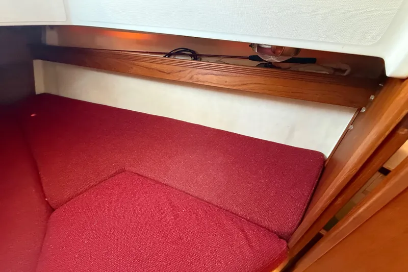 Slide: The Image of Interior cabin of 1986 Sabre 30 MKIII with red cushions and wooden trim. - 39