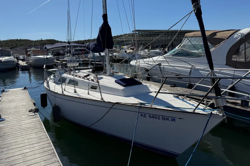 Slide: The Image of 1986 Sabre 30 MKIII sailboat docked at a marina under clear blue skies. - 4