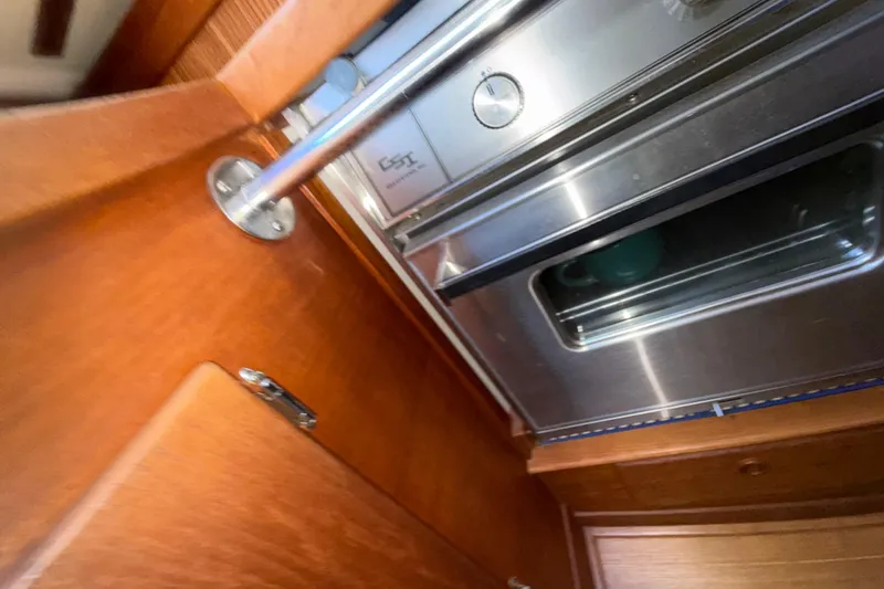 Slide: The Image of Interior of 1986 Sabre 30 MKIII yacht showing stainless steel oven and wooden cabinetry. - 45