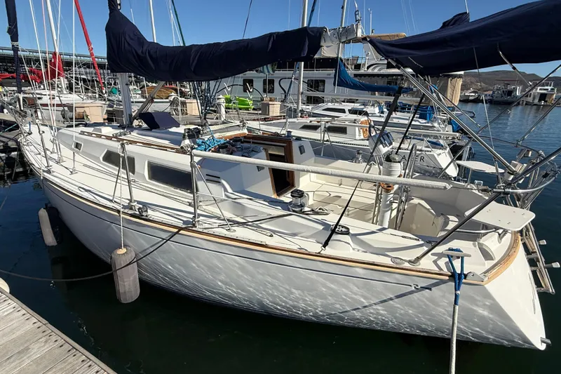 Slide: The Image of 1986 Sabre 30 MKIII sailboat docked in a marina under clear blue skies. - 5