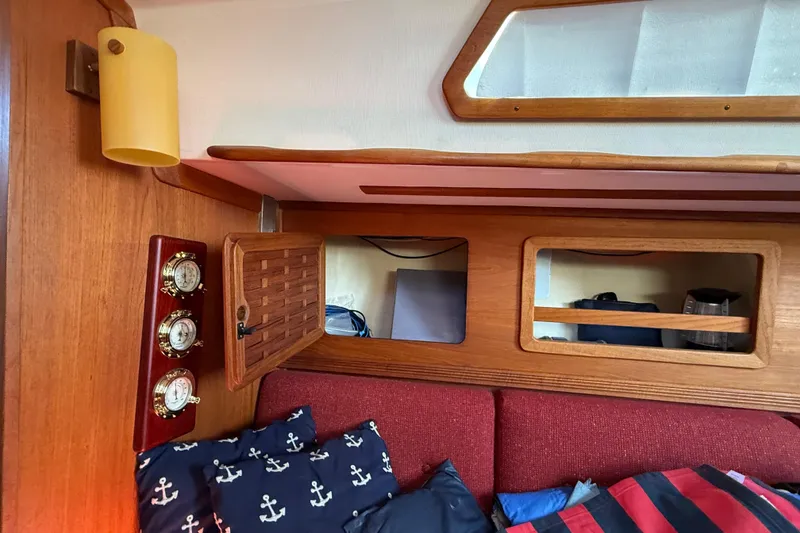 Slide: The Image of Interior of 1986 Sabre 30 MKIII sailboat with wooden cabinetry and nautical-themed decor. - 52