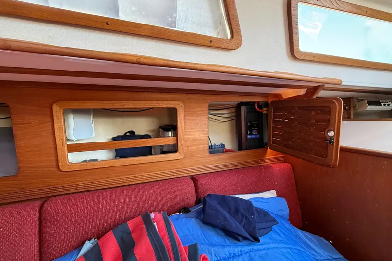 Slide: The Image of Interior of 1986 Sabre 30 MKIII sailboat with wooden cabinetry and red upholstery. - 53