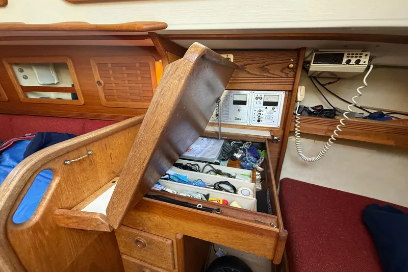 Slide: The Image of 1986 Sabre 30 MKIII sailboat interior with navigation station and storage compartments. - 54