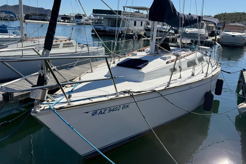 Slide: The Image of 1986 Sabre 30 MKIII sailboat docked in a marina, surrounded by other boats. - 7
