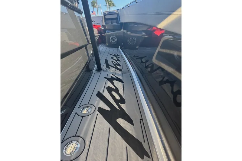 Slide: The Image of 2025 Nor-Tech 390 Sport Center Console deck with logo, sleek design, and modern features. - 10