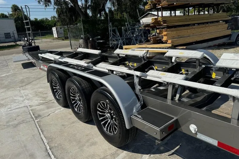 Slide: The Image of Trailer for 2025 Nor-Tech 390 Sport Center Console, featuring triple-axle design. - 19