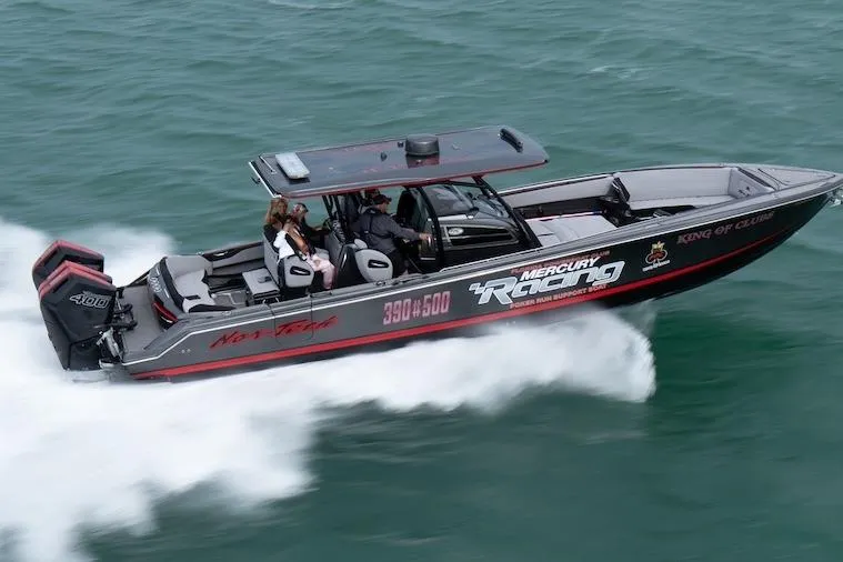 Slide: The Image of 2025 Nor-Tech 390 Sport Center Console boat speeding on water, featuring Mercury Racing engines. - 3